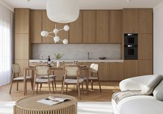 a living room filled with furniture next to a kitchen and dining room table in front of a window