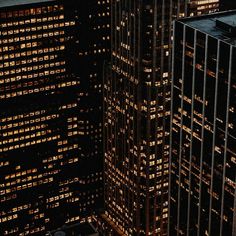 an aerial view of skyscrapers lit up at night