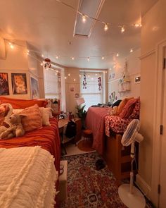 a bedroom with two beds, a rug and lights on the ceiling above them is shown in this image