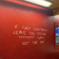 graffiti written on the side of a red wall in front of a window that reads if they leave you feeling something, not the one