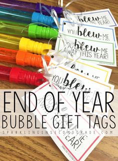 the end of year bubble gift tags are shown with markers on them and tied together