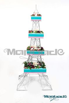 the eiffel tower is decorated with flowers and greenery in blue, pink and white