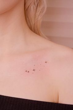 a woman's chest with small stars on it