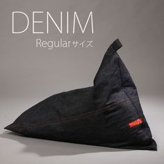 a black triangle shaped pillow sitting on top of a table