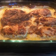 a casserole dish with meat and cheese in it sitting on top of an oven