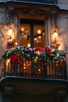 a balcony with christmas decorations and lights on it