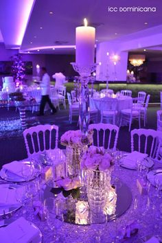 the table is set for an event with purple lighting