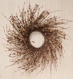 a dried twig wreath hanging on a wall