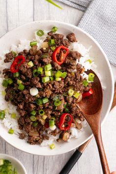 a white bowl filled with rice and meat