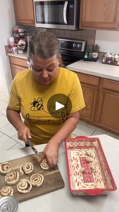 a woman cutting up some food on top of a counter