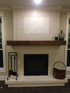 a living room with a fire place and tv above the fireplace