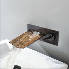 a faucet that has water coming out of it and running down the wall