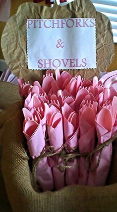 a bouquet of pink paper flowers in a burlocked vase