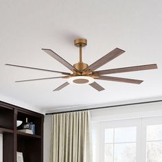 a ceiling fan with wooden blades in a living room