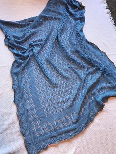 "Soft, luxurious silk and merino wool laceweight yarn in a beautiful light blue with a multicolored edging was used to handknit this large 44\" x 48\" lace patterned shawl.  Made of 50% silk and 50% merino wool, it has a light, almost weightless, soft feel while keeping you warm on a cool evening." Wool Gifts, Fair Isle Cardigan, Merino Wool Scarf, Lace Shawl, Native American Fashion, Wool Socks, Silk Wool, Blue Silk, Lace Pattern