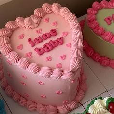 two heart shaped cakes sitting on top of a table