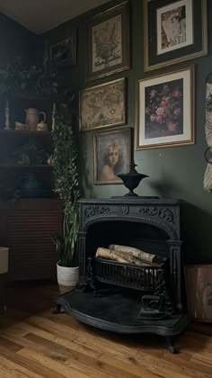 a living room with pictures on the wall and a wood burning stove in the corner