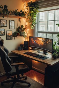 a desk with a computer on it in front of a window filled with potted plants