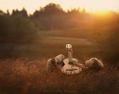 a person laying on the ground with a guitar