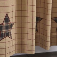 the curtains are decorated with stars and plaid fabric