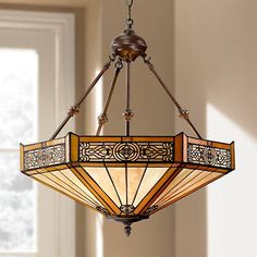 a stained glass chandelier hanging from a ceiling fixture in a room with windows