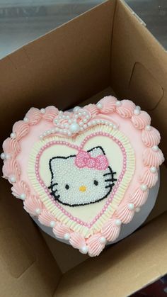 a hello kitty heart shaped cake in a box