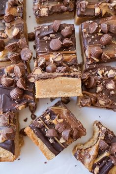 a white plate topped with lots of chocolate and peanut butter cracker bars on top of each other