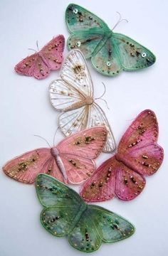 several butterflies are arranged in a row on a white surface