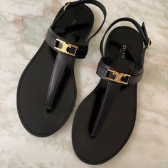 Gorgeous! Celine Lympia Tripmphe Black Leather Sandals. Sz 38.5. Box And Sleeper Bag Included. Gently Worn A Few Times, Signs Of Wear On Outer Soles Otherwise Excellent Condition. Will Fit Us Size 8.5. Retail Price $900. Black Sandals With Gold-tone Hardware For Evening, Chic Black T-strap Sandals With Buckle Closure, Chic Black Toe Post T-strap Sandals, Luxury Black Open Toe T-strap Sandals, Luxury Black T-strap Sandals, Elegant Black Sandals With Gold-tone Hardware, Luxury Black T-strap Sandals With Single Toe Strap, Chic Black T-strap Sandals With Single Toe Strap, Luxury T-strap Sandals For Beach