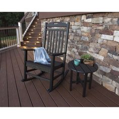 a rocking chair and small table on a deck