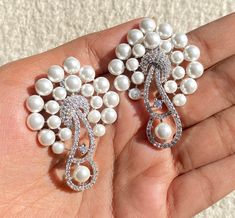 Pearl diamond Earrings featuring semi precious white pearl and cz diamonds. Ideal to pair with your india western sarees and formal outfits. These earrings chendelier design will elevate your look. Perfect gift for her and gift for sister. *𝐏𝐑𝐎𝐃𝐔𝐂𝐓 𝐃𝐄𝐓𝐀𝐈𝐋* * 𝐌𝐚𝐭𝐞𝐫𝐢𝐚𝐥: Brass * 𝐏𝐥𝐚𝐭𝐢𝐧𝐠: White Rhodium Plated * 𝐒𝐭𝐨𝐧𝐞: AAA-quality CZ Diamond. 𝐕𝐢𝐬𝐢𝐭 𝐎𝐮𝐫 𝐅𝐀𝐐𝐬 𝐟𝐨𝐫 𝐒𝐡𝐢𝐩𝐩𝐢𝐧𝐠 𝐏𝐨𝐥𝐢𝐜𝐢𝐞𝐬 𝐚𝐧𝐝 𝐂𝐚𝐫𝐞 𝐈𝐧𝐬𝐭𝐫𝐮𝐜𝐭𝐢𝐨𝐧 *𝐃𝐈𝐒𝐂𝐋𝐀𝐈𝐌𝐄? Luxury Diamond Chandelier Earrings For Wedding, Luxury Silver American Diamond Chandelier Earrings, Western Sarees, Diamond Pearl Earrings, Pearl Diamond Earrings, American Diamond Earrings, Pearl Chandelier Earrings, Pearl Chandelier, Fake Diamond