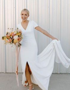 a woman in a white dress holding a bouquet