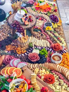 a table filled with lots of different types of food on it's trays