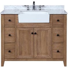 a white sink sitting under a wooden cabinet