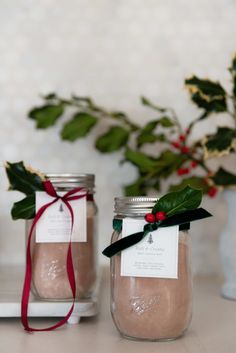 two mason jars with christmas decorations on them