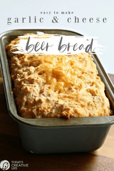 a loaf of beer bread in a pan with the words garlic and cheese on it