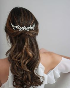 the back of a woman's head wearing a bridal hair comb