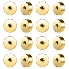 a set of gold metal buttons on a white background