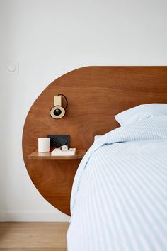 a bed with a wooden headboard next to a night stand