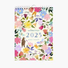 a calendar with colorful flowers and birds on the front, in white paper that says calelierne 205