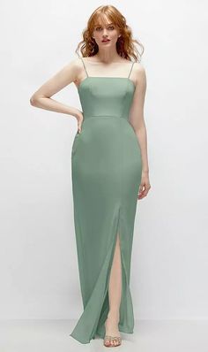 a woman in a long green dress posing for the camera with her hands on her hips