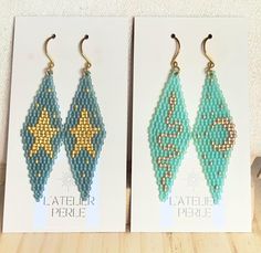 two pairs of beaded earrings are shown in front of a card with the same design on it