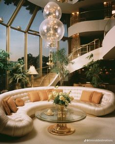 a living room filled with lots of furniture and a chandelier hanging from the ceiling