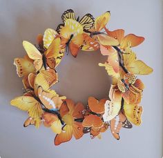 a wreath made out of butterflies on a wall