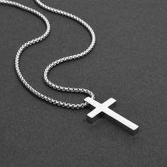 Our Prime Cross Pendants are forged in solid premium steel and the minimal sleek design is definitely a statement piece. This men's pendant necklace is waterproof, tarnish proof and hypoallergenic. The cross cannot be removed from chain. 24 inches long 2mm box chain 31x17mm pendant Made of stainless steel Black plated or regular steel   ► International orders are subject to tax/duty fees. This is uncontrollable on our end. Shipping can take up to 6 weeks due to customs. ► There are no returns/ex Modern Everyday Durable Jewelry, Modern Stainless Steel Necklace With Polished Finish, Minimalist Stainless Steel Cross Necklace With Adjustable Chain, Minimalist Stainless Steel Cross Necklace As A Gift, Minimalist Stainless Steel Cross Necklace For Gift, Minimalist Stainless Steel Jewelry With Shiny Finish, Modern Silver Durable Jewelry, Modern Stainless Steel Box Chain Necklace, Durable Classic Stainless Steel Jewelry