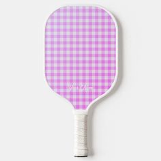 a pink and white checkered ping pong paddle