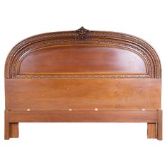 a wooden bed frame with intricate carvings on the headboard and foot board, against a white background