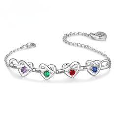 The Engraved Name Birthstone Heart Bracelet is a captivating and personalized piece of jewelry that combines elegance with a heartfelt touch. Crafted from high quality materials, this bracelet features a lustrous finish that makes it a versatile accessory suitable for both everyday wear and special occasions. The centerpiece of this bracelet is beautifully shaped hearts, polished to a mirror finish and designed to catch the eye. These hearts serve as a canvas for personalization; they each hold a vibrant birthstone. These gems represent the birth month of the wearer or someone dear to them, adding a colorful and personal significance to the bracelet. Engraving a name or a meaningful word next to each heart, makes the piece truly unique to the wearer.  The bracelet is designed with an adjus Silver Bracelets For Women, Infinity Love, Moms Bracelet, Personalized Mother's Day Gifts, Birthstone Bracelet, Christmas Bracelet, Engraved Bracelet, Birthstone Bracelets, Elegant Bracelet