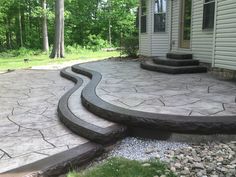 a stone patio with steps leading up to it