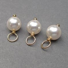 These dangles were created using approx. 6mm White Swarovski pearls. Each pearl has been wire wrapped on a 14k gold fill ball end headpin. Pearl is the birthstone charm for June. This listing is for 3 dangles. MORE PEARLS: https://www.etsy.com/shop/TheDangleDiva?ref=hdr_shop_menu§ion_id=7328420 MORE Dangles and Pendants: http://www.thedanglediva.etsy.com FOLLOW me: www.facebook.com/thedanglediva for new designs and discount coupons INTERCHANGEABLE EARRINGS: https://www.etsy.com/shop/TheDangleDiv Pearl Bangle Bracelet, Charms Collection, Interchangeable Earrings, Pearl Birthstone, Rose Gold Pearl, Necklace Charms, White Pearl Earring, Charms Necklace, Pearl Bangle